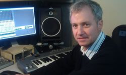 Photo of the author in front of a pro tools audio production desktop