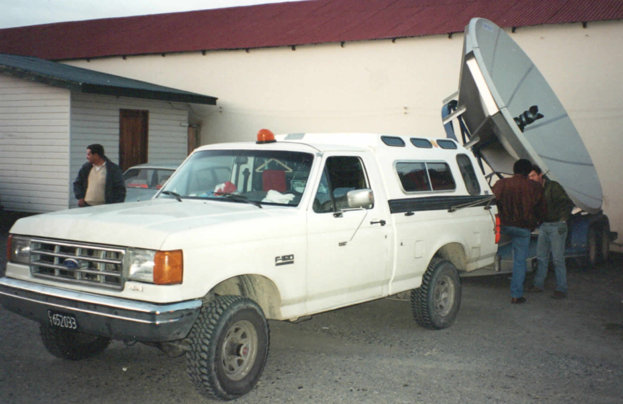 Picture of an SUV with a low trailer carrying a large satellite uplink dish and other equipment