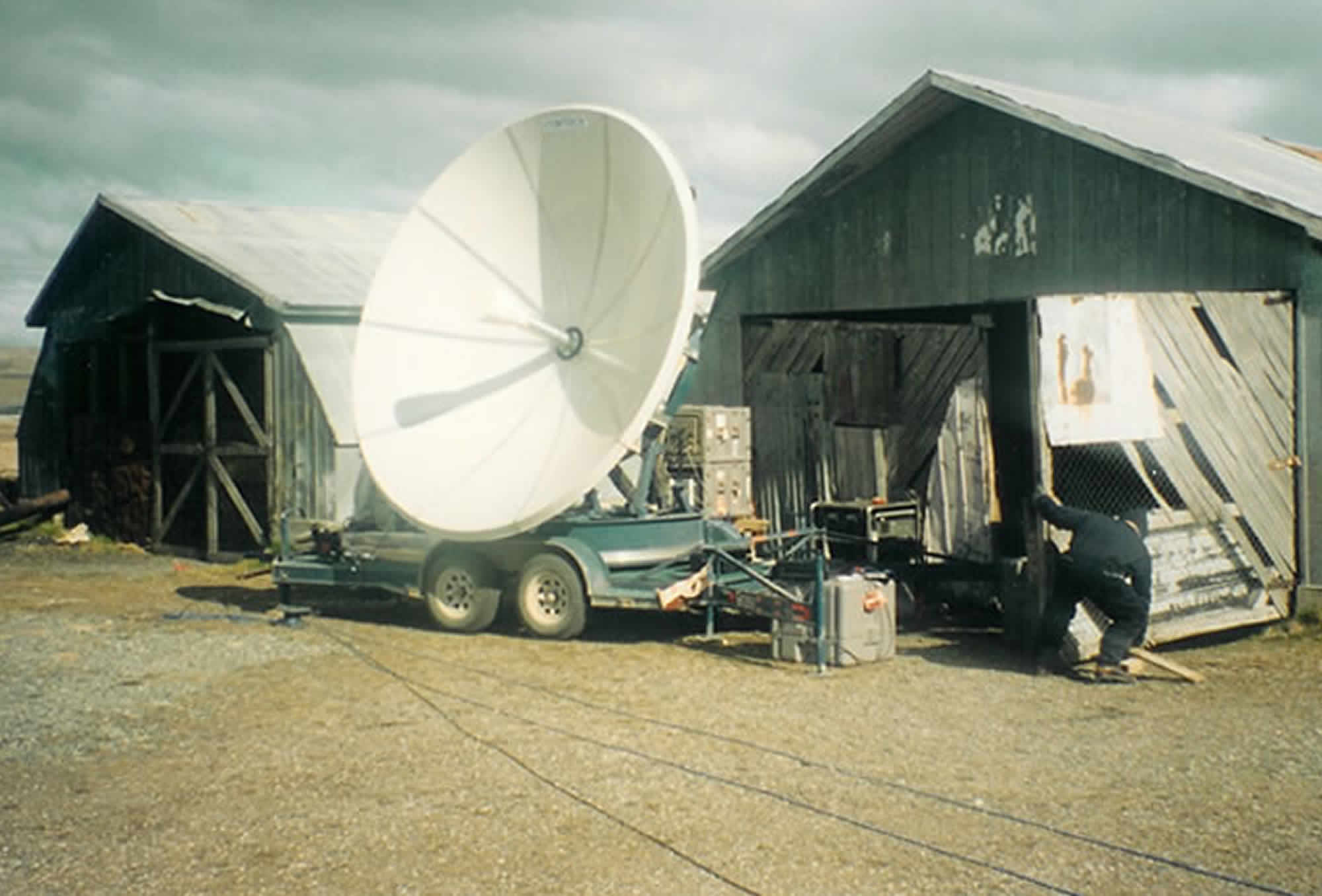 Photo of satellite dish set up sheltered by the barn