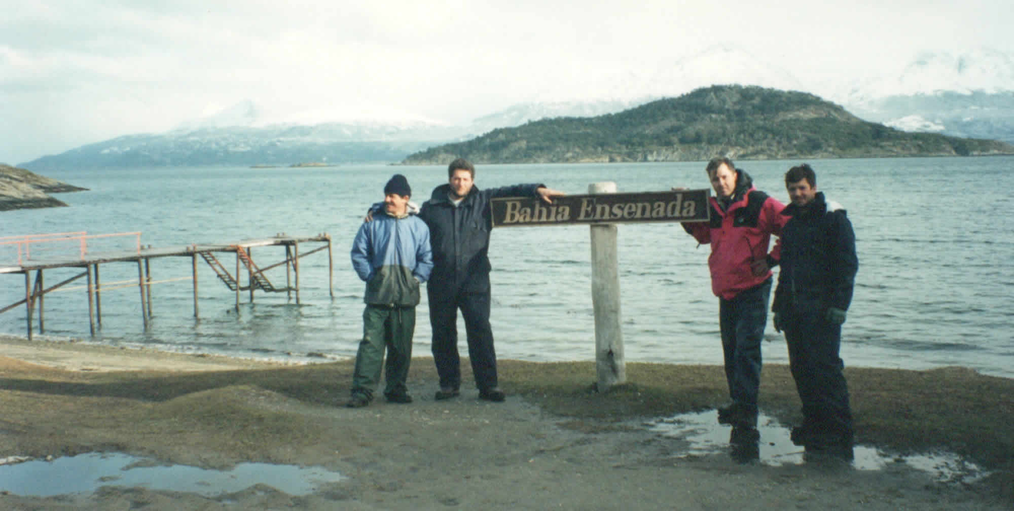 Photo of Bahia Ensenada beach sign with the author and some of the Keytech satellite engineering crew