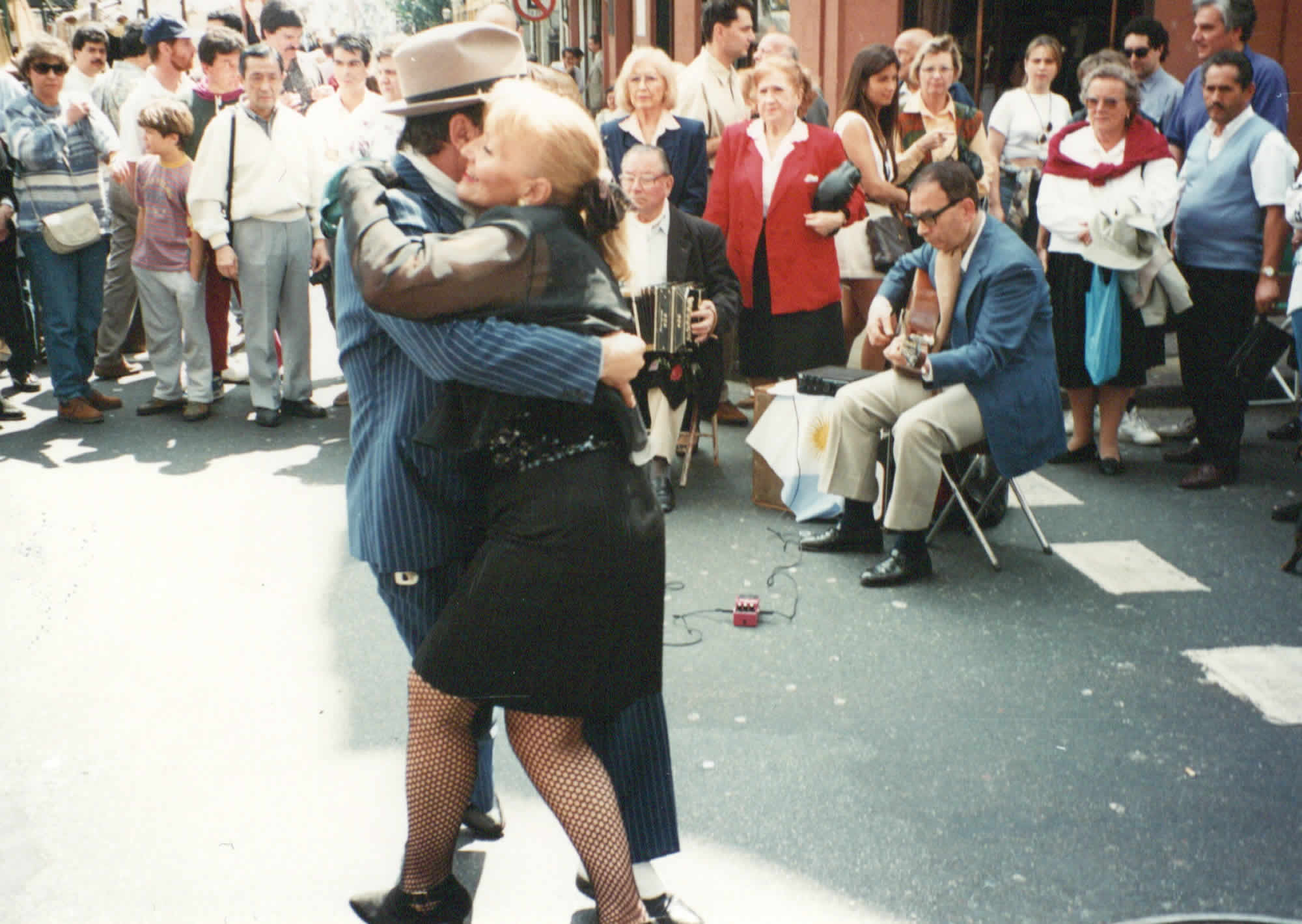 Photo of a couple dancing street Tango in Buenos Aires - others joined in