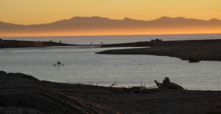 Photo of sunrise across an estuary, South Island, New Zealand.